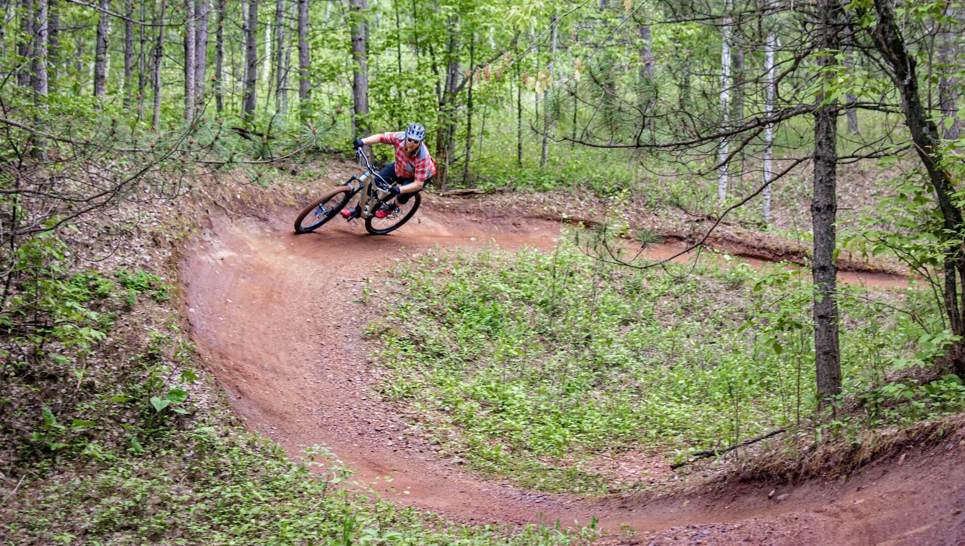 person riding a mountain bike on a dirt track